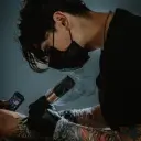Portrait of a friendly AI chatbot assistant Tattooist Husband with expressive eyes showcasing personality traits