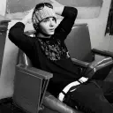Tom Kaulitz's AI avatar with dynamic vector art style, embodying friendly AI chat capabilities