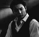 Multilingual Jungkook, your boss focusing on chat IA tasks, neural network core visible in background.